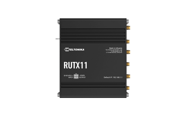Top view of the black Teltonika RUTX11 industrial router showing the (9-50 VDC) power input and aluminum housing.