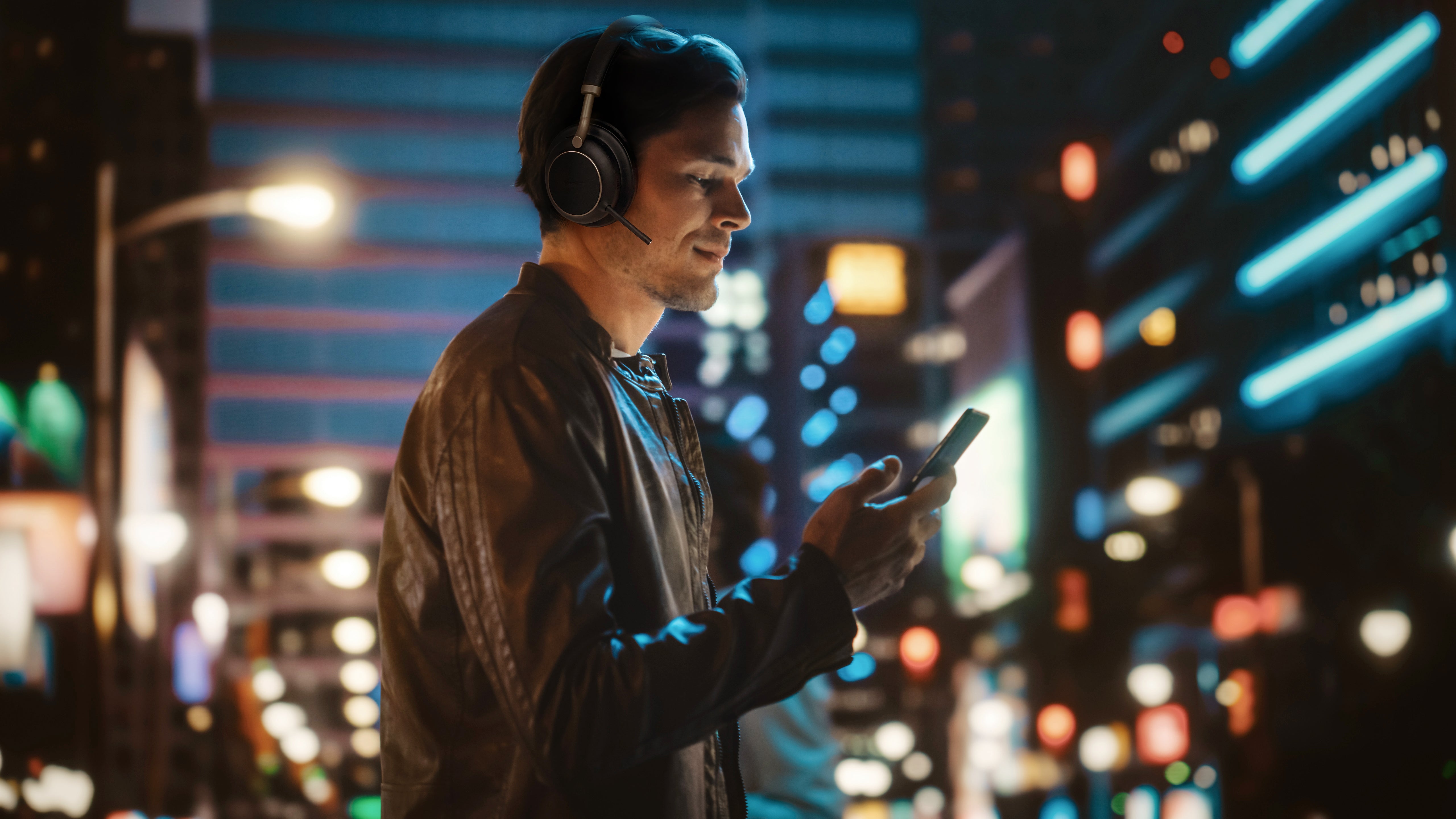 Image of user pairing Yealink BH76 Plus Teams headset with smartphone in noisy city environment.